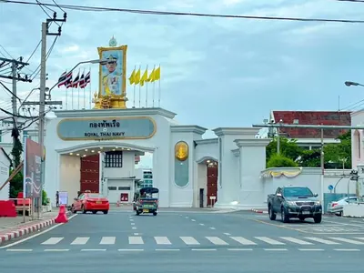 a building on a street with cars in front of it at Entire House 3BR - White and Green Guesthouse in Bangkok Yai