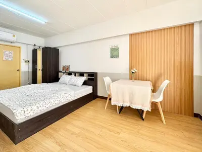 a bedroom with a bed and a table and chairs at Budget 1b1b Heart of Ramkamheng in Sathani Khlong Tan