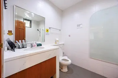 a bathroom with a sink and a toilet and a mirror at Bangkok Manor One\u66fc\u8c37\u58f9\u53f7\u5e84\u56ed in Bangkok