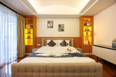 a bedroom with a large bed with a large window at Bangkok Manor One\u66fc\u8c37\u58f9\u53f7\u5e84\u56ed in Bangkok