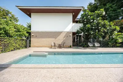 a swimming pool in front of a house at Bangkok Manor One\u66fc\u8c37\u58f9\u53f7\u5e84\u56ed in Bangkok