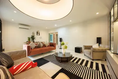 a living room with a couch and a table at Bangkok Manor One\u66fc\u8c37\u58f9\u53f7\u5e84\u56ed in Bangkok