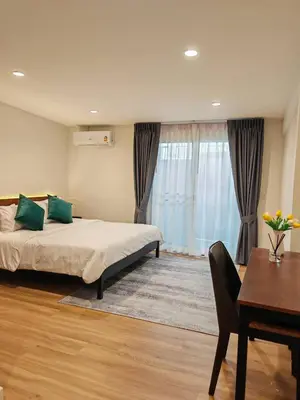 a hotel room with a bed and a table and a dining room at Super cozy new townhome in central of Bangkok 4 PAX in Ban Chek
