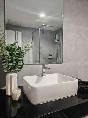 a bathroom with a white sink and a mirror at Super cozy new townhome in central of Bangkok 4 PAX in Ban Chek