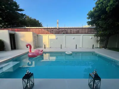 a swimming pool with a pink swan and a float at Bangkok Manor Two\u66fc\u8c37\u8d30\u53f7\u5e84\u56ed in Bangkok