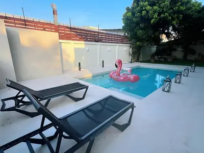 a swimming pool with a pink swan in it at Bangkok Manor Two\u66fc\u8c37\u8d30\u53f7\u5e84\u56ed in Bangkok
