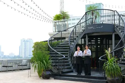 two women standing in front of a spiral staircase at Hotel Once Bangkok in Bangkok