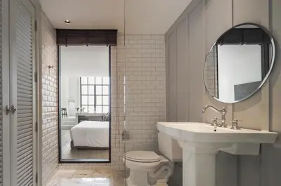 a bathroom with a sink and a toilet and a mirror at Hotel Once Bangkok in Bangkok