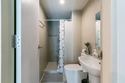 a bathroom with a toilet and a sink at TC Contel at Bts Samrong in Ban Khlong Samrong