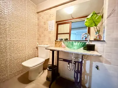 a bathroom with a sink and a toilet at WiNNiNE Cozy Home in Bangkok