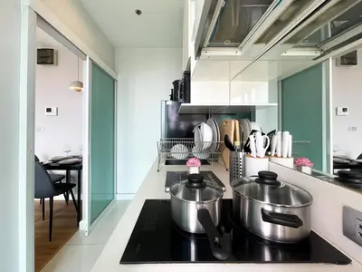 a kitchen with two pots on top of a stove at Prime Sukhumvit Stay 1 BR - Fast WiFi - BTS Udomsuk in Bangkok