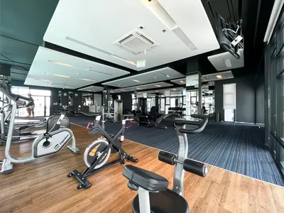 a gym with several exercise bikes and treadmills at Prime Sukhumvit Stay 1 BR - Fast WiFi - BTS Udomsuk in Bangkok