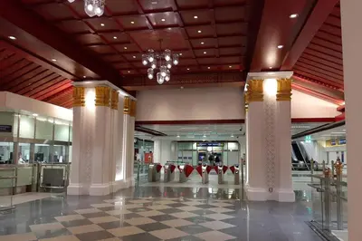 a lobby with columns and a chandelier in a mall at Chaiwat Guesthouse in Bangkok