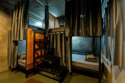 a bedroom with two bunk beds and a ladder at Another High Away Hostel - Bangkok in Nonthaburi