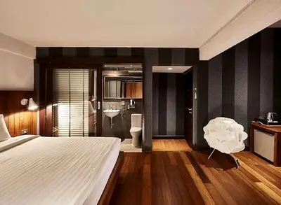 a bedroom with a bed and a bathroom with a sink at XX Wish Inn Silom Bangkok - วิชอินน์ สีลม กรุงเทพ in Bangkok