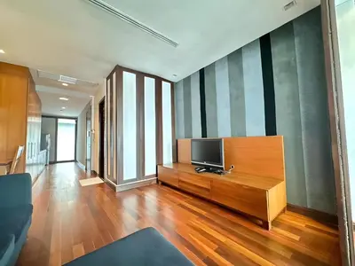 a living room with a television on a wooden dresser at XX Wish Inn Silom Decho Road - วิช อินน์ สีลม เดโช in Bangkok
