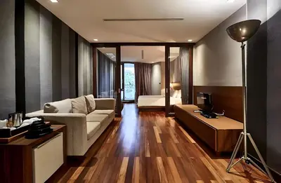 a living room with a couch and a bed at XX Wish Inn Silom Decho Road - วิช อินน์ สีลม เดโช in Bangkok