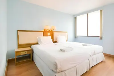 a bedroom with a large white bed and a window at XX Wish Inn Chidlom Bangkok - วิชอินน์ ชิดลม กรุงเทพ in Pratunam