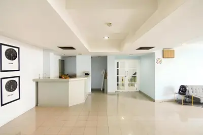 a large room with white walls and a tile floor at XX Wish Inn Chidlom Bangkok - วิชอินน์ ชิดลม กรุงเทพ in Pratunam