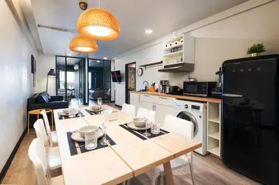 a kitchen and dining room with a table and chairs at 2 bedroom state tower Sathorn in Bangkok