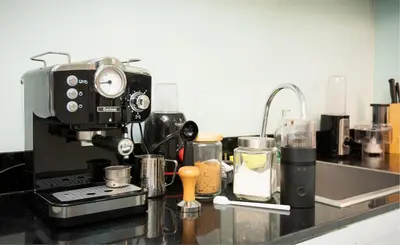 a kitchen counter with a coffee maker on a counter top at 2 bedroom state tower Sathorn in Bangkok