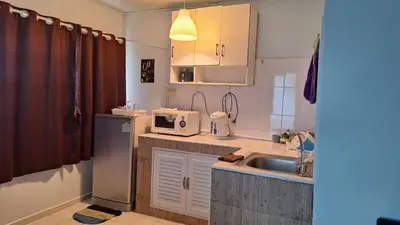 a small kitchen with a sink and a microwave at Popular Muang Thong Condo, Building C5 in Ban Bang Phang