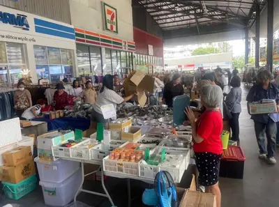 a group of people standing at tables in a market at Popular Muang Thong Condo, Building C5 in Ban Bang Phang