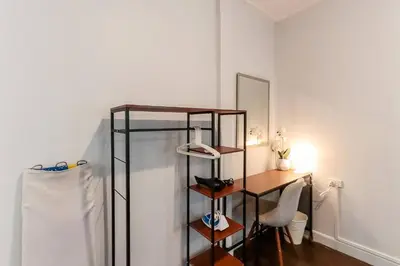 a room with a glass shelf and a desk and a mirror at Charming 2-Storey House in Bang Son, Bangkok in Bangkok