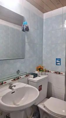 a bathroom with a sink and a toilet and a mirror at Popular Muang Thong C5 in Thung Si Kan