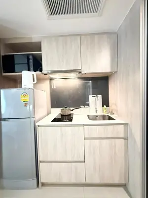 a kitchen with a white refrigerator and a sink at BTS Thong Lor Downtown Low-rise Large Studio #Private Courtyard Super Large Pool in Bangkok