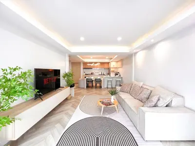a living room with a couch and a table at Onsen Wellness Retreat House in Bangkok