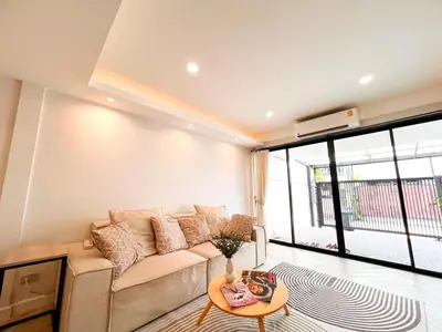 a living room with a couch and a table at Onsen Wellness Retreat House in Bangkok