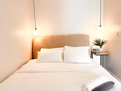 a bedroom with a large bed with white pillows at Onsen Wellness Retreat House in Bangkok