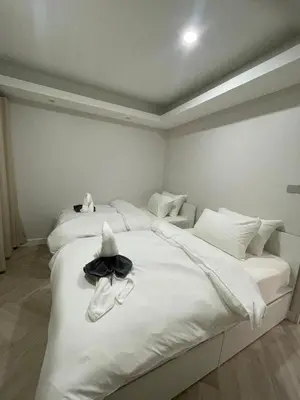 a bedroom with two beds with a hat on it at Onsen Wellness Retreat House in Bangkok
