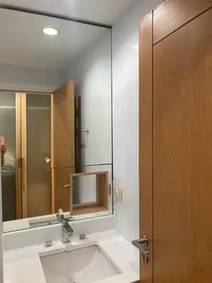 a bathroom with a sink and a mirror at 'City Retreat' Asok Sukhumvit 23 Room 53 sqm in Bangkok