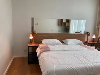 a bedroom with a large bed with two pillows at 'City Retreat' Asok Sukhumvit 23 Room 53 sqm in Bangkok