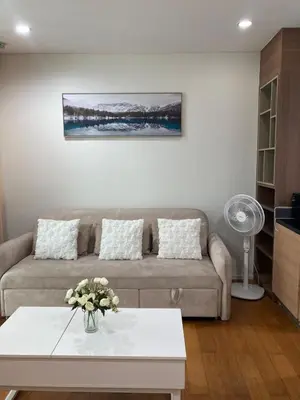 a living room with a couch and a table at 'City Retreat' Asok Sukhumvit 23 Room 53 sqm in Bangkok