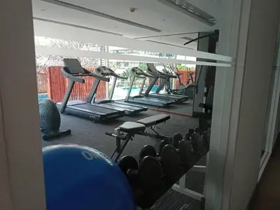 a row of exercise machines in a gym at 'City Retreat' Asok Sukhumvit 23 Room 53 sqm in Bangkok