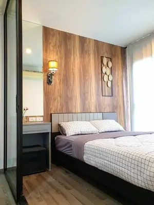 a bedroom with a bed with a wooden wall at Immaculate Quite Resort Home, brand new ACsWiFi in Amphoe Phra Khanong