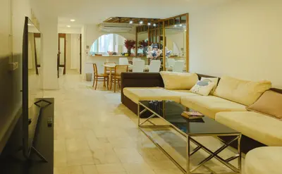 a living room with a couch and a table at Big unit for 8 people, city center Silom in Bangkok