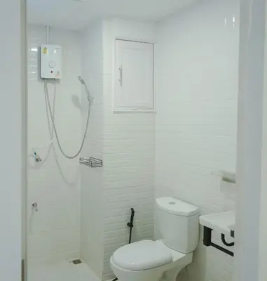 a white bathroom with a shower and a toilet at Big unit for 8 people, city center Silom in Bangkok