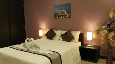 a hotel room with two beds with white sheets at Leelawadee Modern Resort Huaykwang - ลีลาวดี ห้วยขวาง in Bangkok