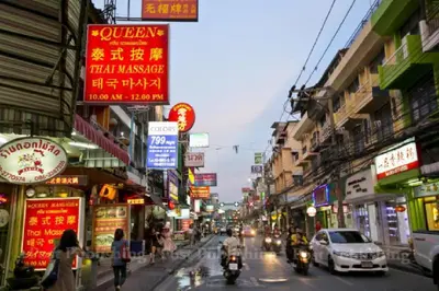a busy street in an asian city with cars and motorcycles at Leelawadee Modern Resort Huaykwang - ลีลาวดี ห้วยขวาง in Bangkok