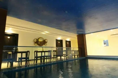 a house with a swimming pool and a dining room at Leelawadee Modern Resort Huaykwang - ลีลาวดี ห้วยขวาง in Bangkok