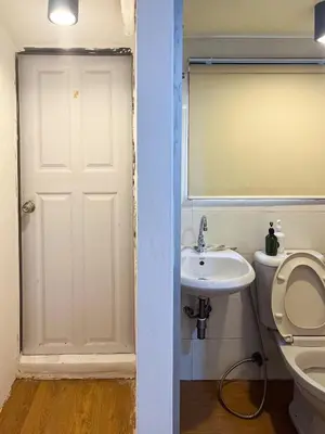 a bathroom with a toilet and a sink and a mirror at Chubbi 5 Room1 in Ban Bang Bamru
