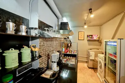 a kitchen with a counter with a coffee maker at Bangkok Bed and Bike in Bangkok