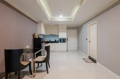 a kitchen with a table and chairs in a room at High-Floor City View Near SIAM in Bangkok
