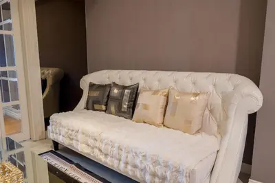 a white couch with pillows on it in a room at High-Floor City View Near SIAM in Bangkok