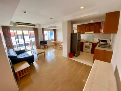 a kitchen and living room with a couch and a table at ศรีย่าน เรสซิเดนซ์ Sriyan Residence in Dusit
