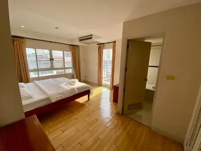 a bedroom with a bed and an open door at ศรีย่าน เรสซิเดนซ์ Sriyan Residence in Dusit